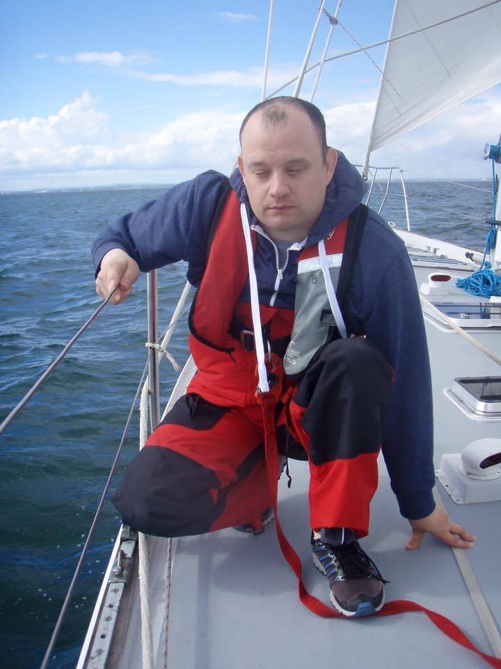 A man on a sailing boat.