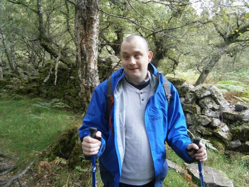 An image of a man in a coat on a walk.