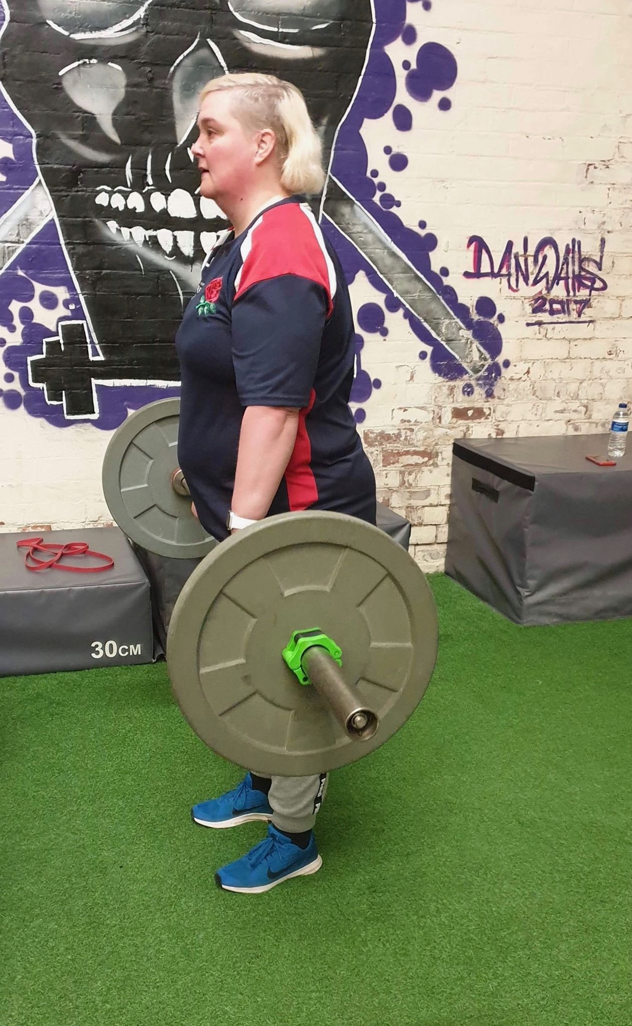 An image of a woman lifting weights.